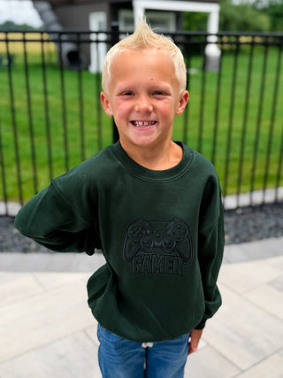 Kids dark green crewneck sweatshirt with gamer graphic on front