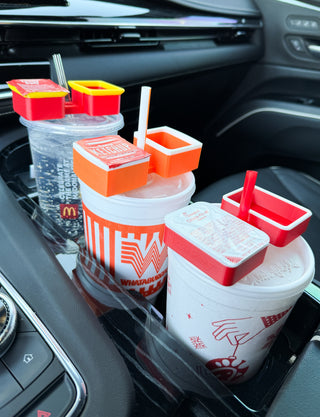 Two condiment cup sets with straws and lidded holders in orange and red on drink cups