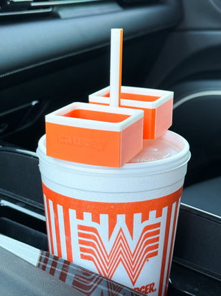 Orange sauce cup set with two condiment holders, straw, and striped W graphic drink cup