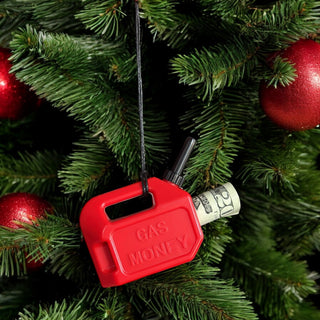 Red gas can ornament with “GAS MONEY” text, hanging on a tree