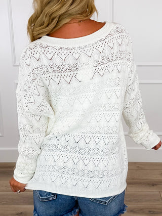 White long sleeve knit sweater back view with diamond zigzag pattern and rib hem