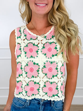 Ivory crochet cropped tank top with pink floral medallions and green vines, scalloped edge