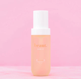 beaut. body oil bottle with translucent golden liquid, pump cap