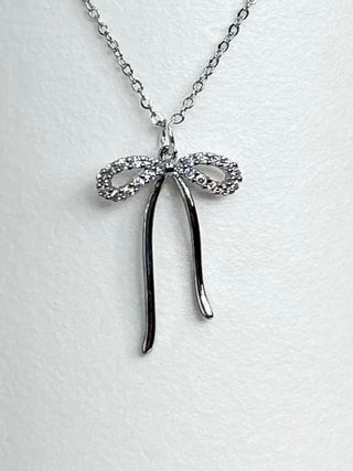 Silver-tone bow pendant necklace with glitter ribbon and long drops