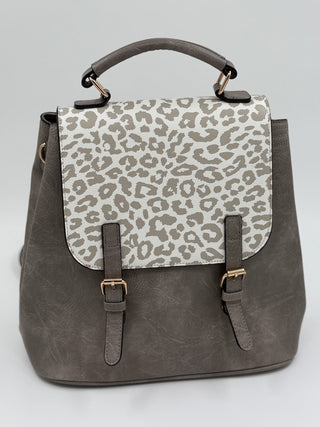 Convertible leather backpack with leopard-print flap, two front buckles, top handles, straps