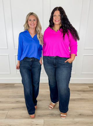 Lightweight 3/4 sleeve V-neck tops in blue and bright pink on two models.