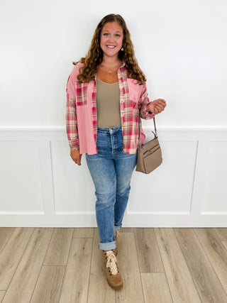 Pink plaid long-sleeve button-up top worn over a tank and jeans, full length view