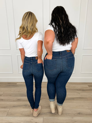Dark wash skinny jeans, non-distressed, back pockets and belt loops, full length