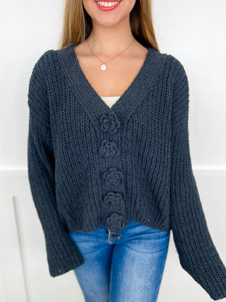 Charcoal grey knit long-sleeve cardigan with V-neck and button placket, cable texture