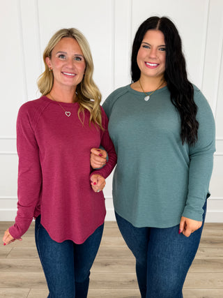 Knit long-sleeve top in wine red and teal, crew neckline, curved hem