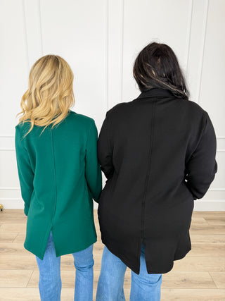 Back view long-sleeve knit jacket in black and green, button front, mid-thigh.
