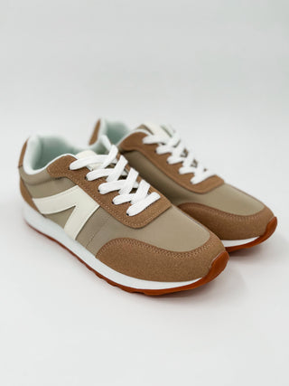 Color-block sneakers in tan and brown with cream panels, white laces, orange sole