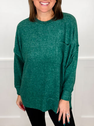 Heather green long-sleeve knit top with crew neck and chest pocket