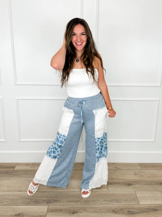 High-rise knit pants, blue drawstring waist with wide legs and white lace floral side panels