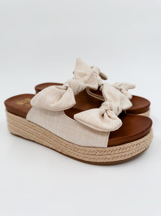 Natural linen wedge sandals with bow-tie straps and braided jute platform