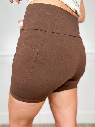 Brown high-rise cotton blend biker shorts with a wide waistband and stitched seams