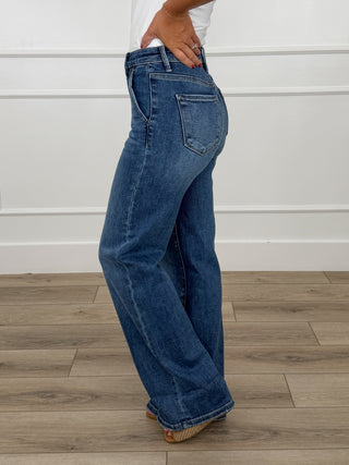 Women’s wide-leg dark denim jeans, back view, with fitted waistband and belt loops