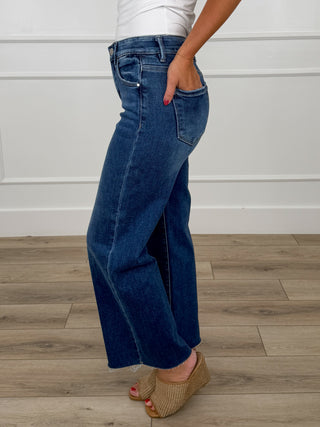 Dark wash mid-rise wide-leg cropped jeans with raw hem, non-distressed