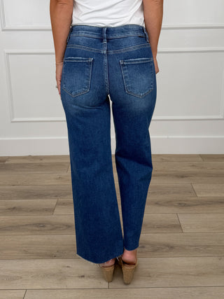 Dark wash mid-rise wide-leg cropped jeans with raw hem and back patch pockets