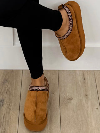 Tan/brown faux suede platform slip-on shoes with patterned trim and rounded toe