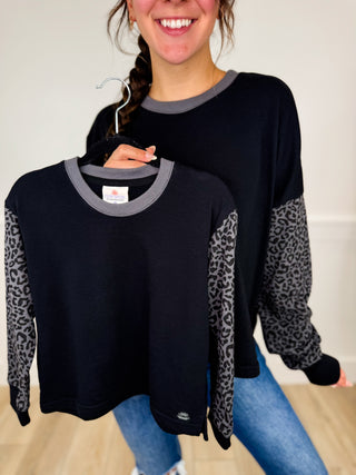 Black long sleeve top with gray crew neck and leopard-print contrast sleeves