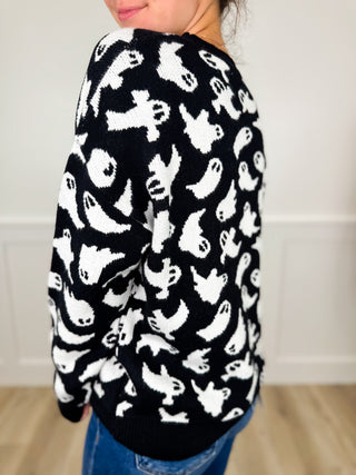 Black knit long-sleeve sweater with allover white cat pattern, crew neck