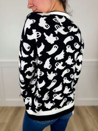 Ghost-pattern knit cardigan, black with white scattered designs; long sleeves