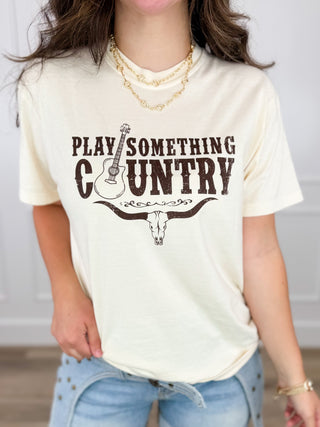 Cream cotton short-sleeve graphic tee shirt with "PLAY SOMETHING COUNTRY" front print