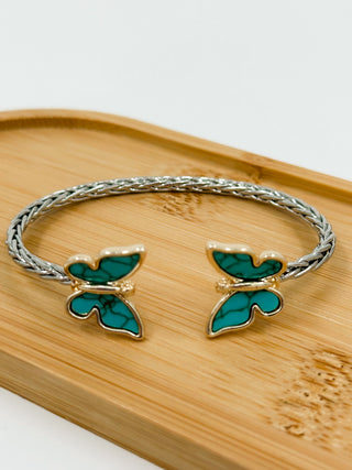 Silver cuff bracelet with two green butterfly charms