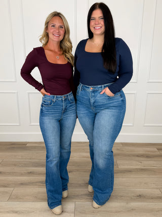 Women's medium wash flare jeans with belt loops, button fly, and flared legs