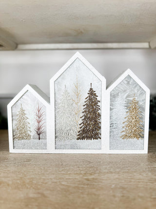 White house-shaped winter decor with glitter trees and scenic winter inserts
