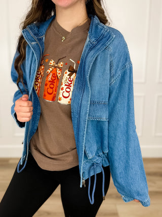 Medium wash denim long-sleeve jacket with button front and flap chest pockets