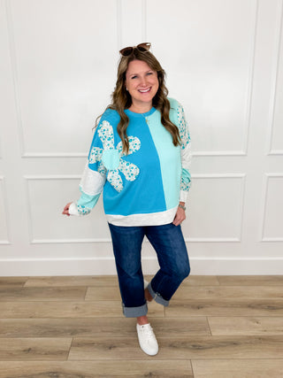 Long-sleeve cotton-blend top in teal and blue with floral four-petal graphic and gray trim
