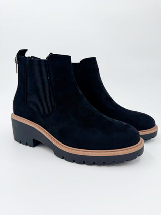 Black faux suede Chelsea booties with elastic side panels and chunky tread sole