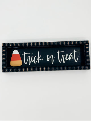 Halloween wood sign with Trick or Treat text and candy corn graphic