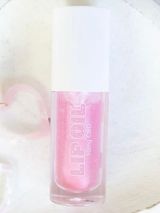 Tinted CBD lip oil, pink shade in clear bottle with white cap, 50mg