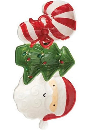 Stoneware tidbit dish with candy-cane swirls, holly leaves, and red striped lid
