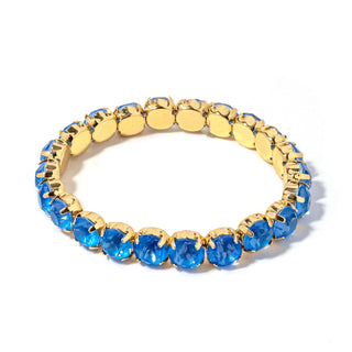 Gold-tone bracelet with oval cobalt-blue faceted stones and gold disc links