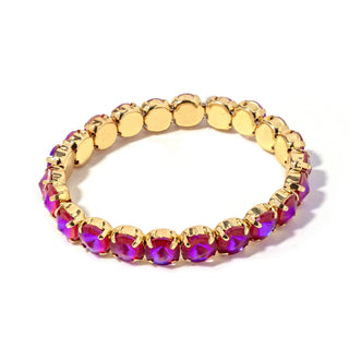 Gold-tone bracelet with oval magenta-purple faceted stones and gold disc links