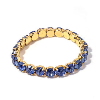Gold-tone bracelet with dark blue faceted stones and round link settings