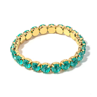 Gold-tone bracelet with oval teal-green faceted stones and gold disc links