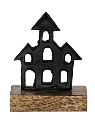 Black house-shaped decorative figure with arched windows on a wooden base