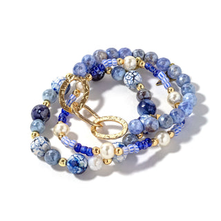 Beaded bracelet set with blue beads, gold chain links, and pearl and dark bead accents