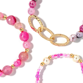 Beaded bracelet set with pink beads, gold chain links, and pearl accents