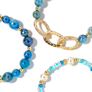 Beaded bracelet set with turquoise and blue beads, gold chain links, and pearl accents