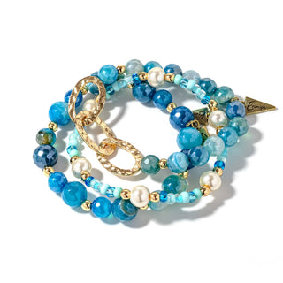 Beaded bracelet set with blue and teal beads, gold chain links, and pearl accents
