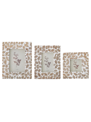 Wood picture frames with leaf pattern, showing three different photo openings