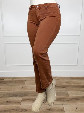 Brown mid-rise straight-leg jeans with five-pocket design, side view