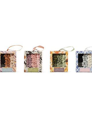 Assorted satin scrunchie bunch in copper, pink, green, and blue boxes