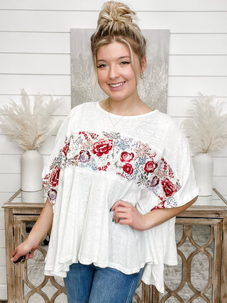 Cotton blend short-sleeve top in white with red floral embroidery across front